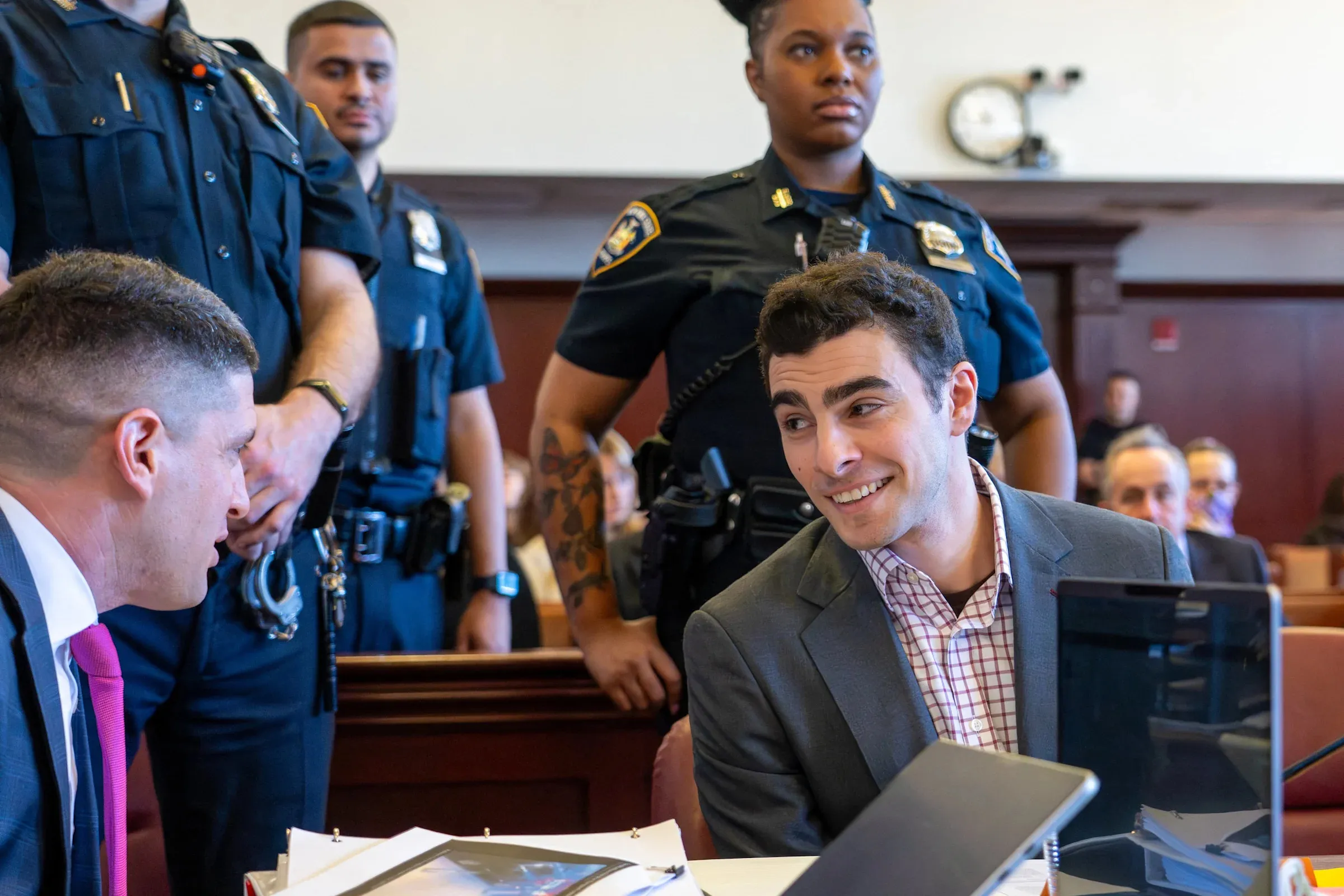 Grinning Luigi Mangione Observes Fans in Chaotic Courtroom Scene