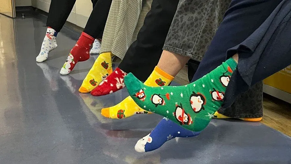 Hospital employees wear festive socks to celebrate Christmas.