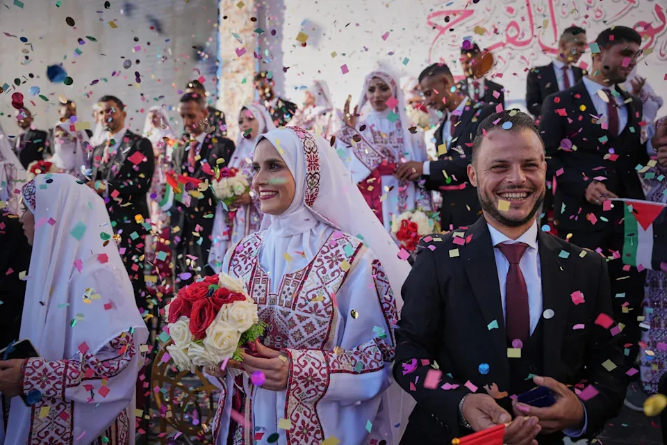 Photos of Palestinian couples celebrating a large wedding in Gaza during a fragile ceasefire.