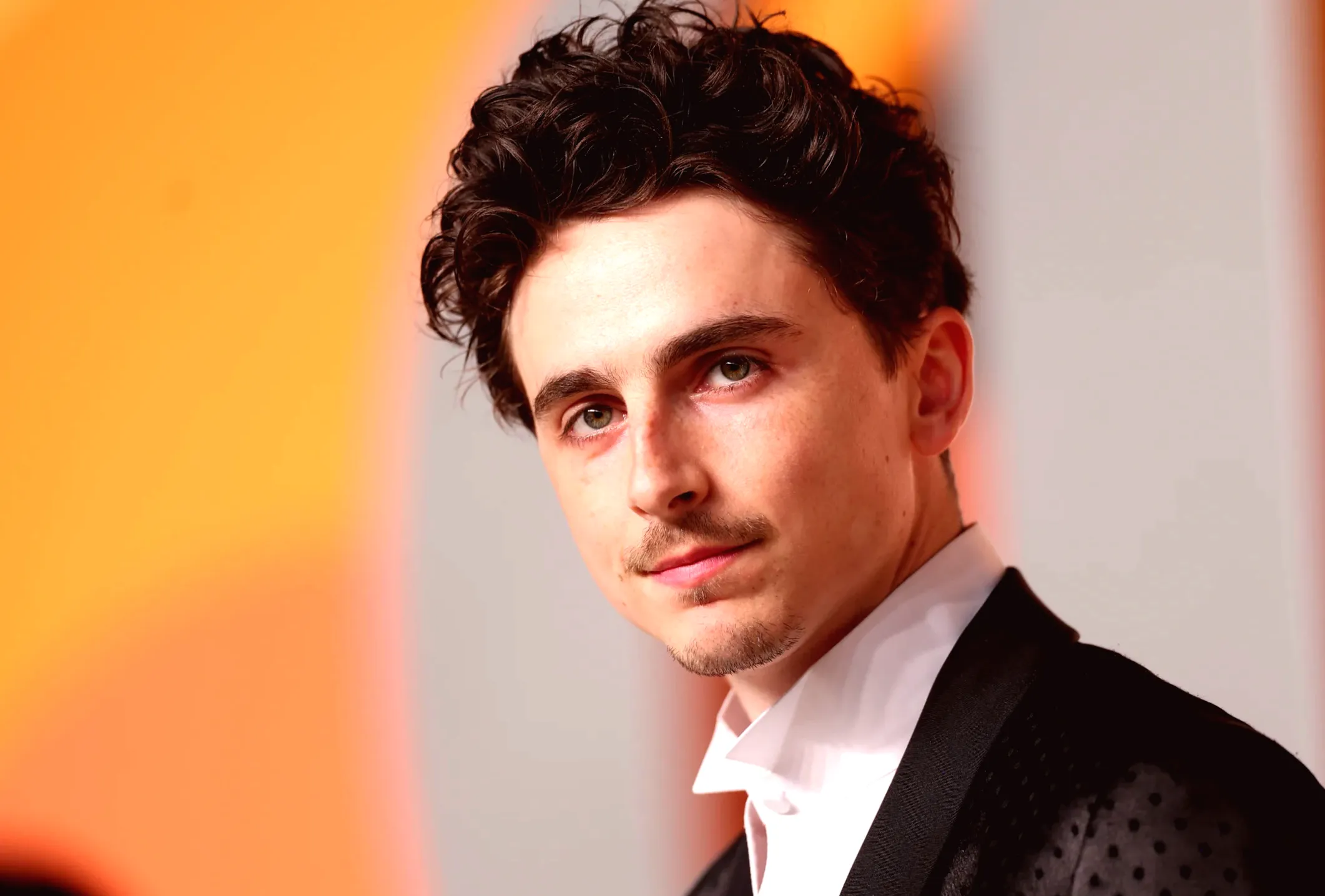 Timothée Chalamet dances to "Crank That" and wears fan-made flag of his face during high-energy visit to Brazil.