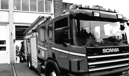 Firefighters are battling a building fire while a city road remains closed.