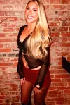 Ex-NFL Cheerleader Shannon St. Clair Stuns in Risque Sheer Top and Leather Mini Shorts