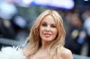 Kylie Minogue switches from her signature rock star layers to blunt front bangs